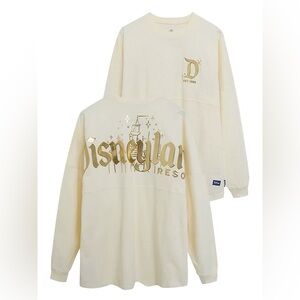 Disneyland Gold Pixie Dust Spirit Jersey featuring a cream-colored fabric